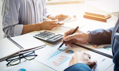 business man financial inspector and secretary making report, calculating or checking balance. Internal Revenue Service inspector checking document. Audit concept